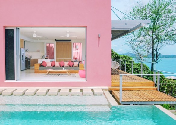 Pink building with aqua pool out front
