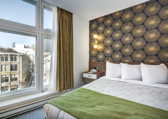 Interior of a hotel room with a city view