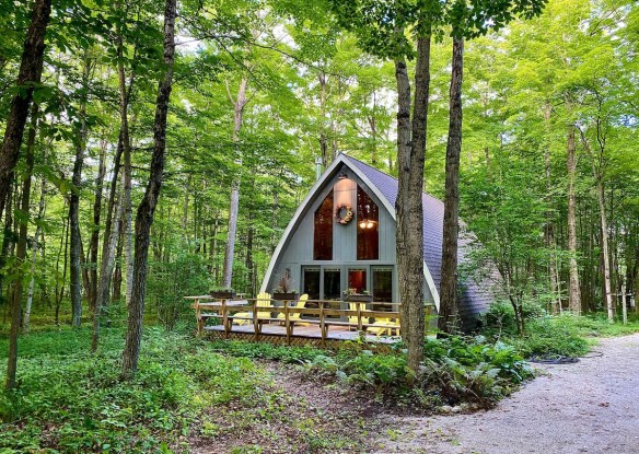 Cute cabin exterior with yellow chairs
