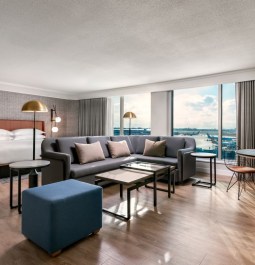 Interior of a spacious hotel suite with runway views